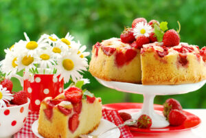 strawberry sponge cake with fresh fruits decoration on table in the garden ** Note: Shallow depth of field